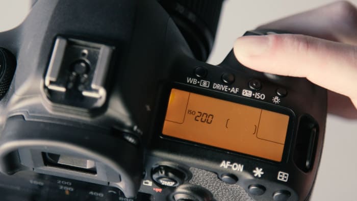 A close up of a DSLR camera showing the ISO value