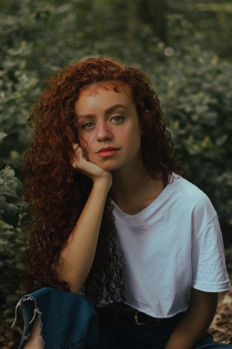 profile photo of a girl with red hair in a field 